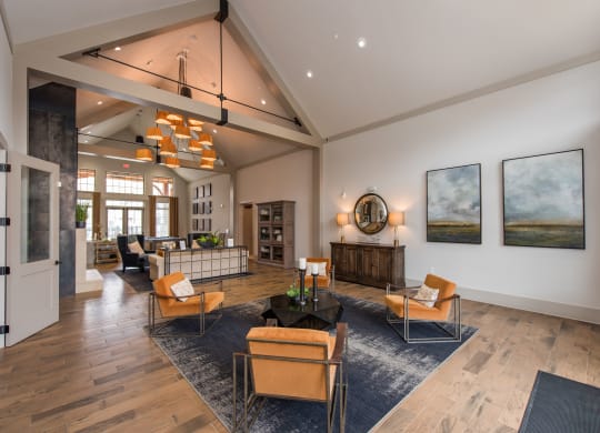 a large living room with a vaulted ceiling and hardwood flooring at The Whitworth, Williamsburg, VA
