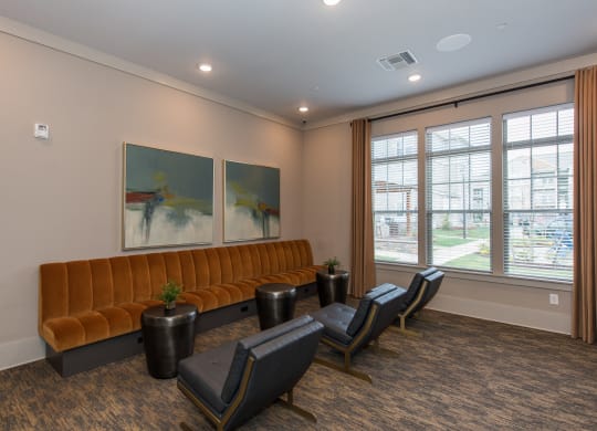 a room with a couch chairs and paintings on the wall at The Whitworth, Williamsburg, VA, 23185