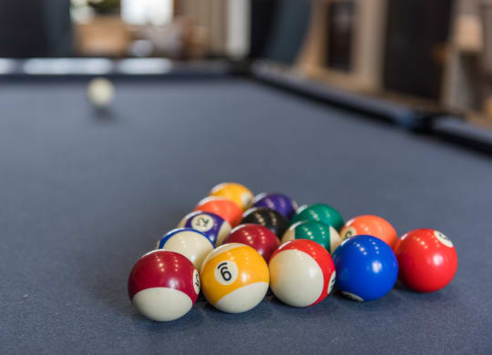 a pile of pool balls on a pool table at The Whitworth, Virginia, 23185