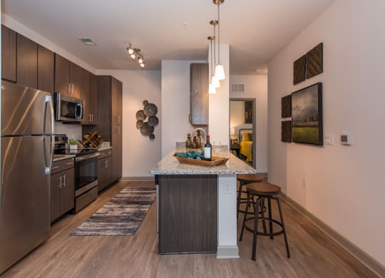 a kitchen with a large island and stainless steel appliances at The Whitworth, Williamsburg, VA, 23185