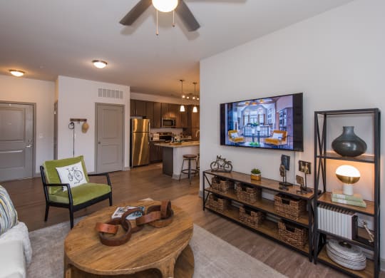 a living room with a ceiling fan and a flat screen tv at The Whitworth, Williamsburg, 23185