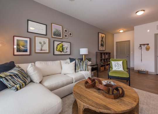 a living room with a white couch and a wooden coffee table at The Whitworth, Williamsburg, Virginia