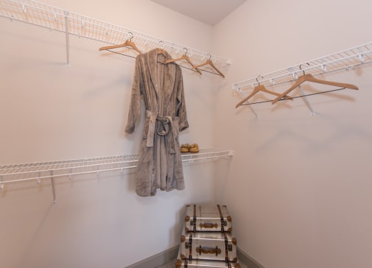 a walk in closet with a robe hanging on the wall at The Whitworth, Williamsburg, VA