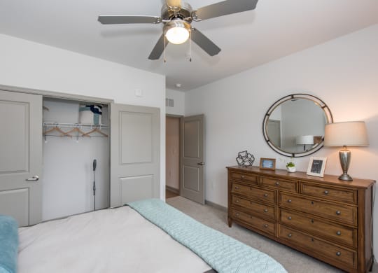 a bedroom with a bed and a dresser with a mirror at The Whitworth, Williamsburg, Virginia