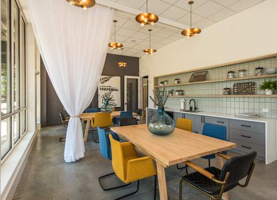 a dining room with a wooden table and yellow chairs