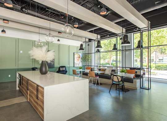 a large room with a kitchen island and a living room with couches