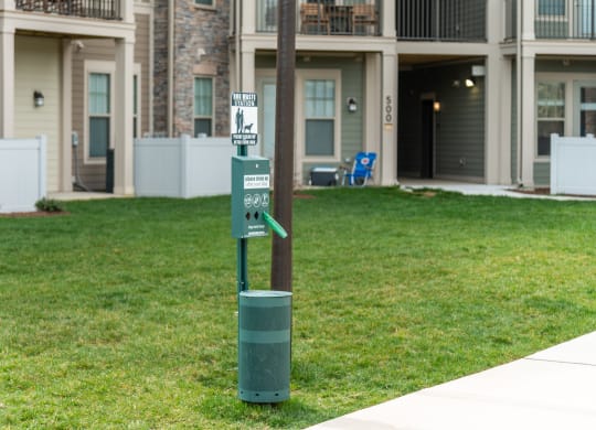 a recycling bin sits next to a pole in front of a building at The Whitworth, Virginia, 23185