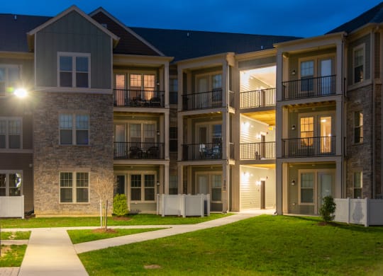 an apartment building lit up at night at The Whitworth, Williamsburg, VA