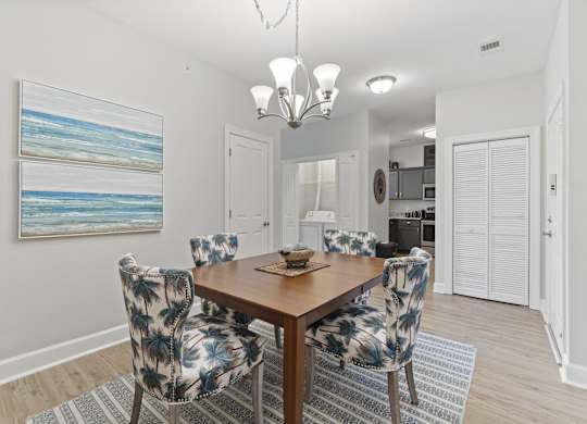 A dining room with a wooden table and chairs with a blue and white pattern.