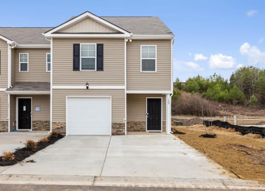 a tan house with a white garage door at Summit Place Apartments, Oak Ridge, TN, 37830