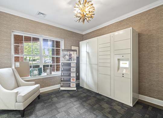 the living room has a large window and a white dresser with a white chair