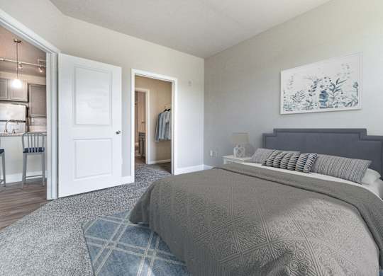 A bedroom with a large bed and a painting on the wall.