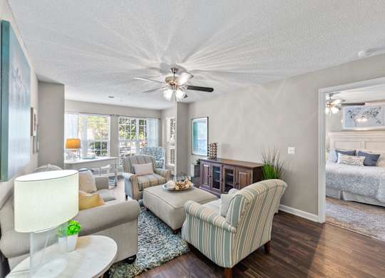 A living room with a striped armchair and a white lamp.