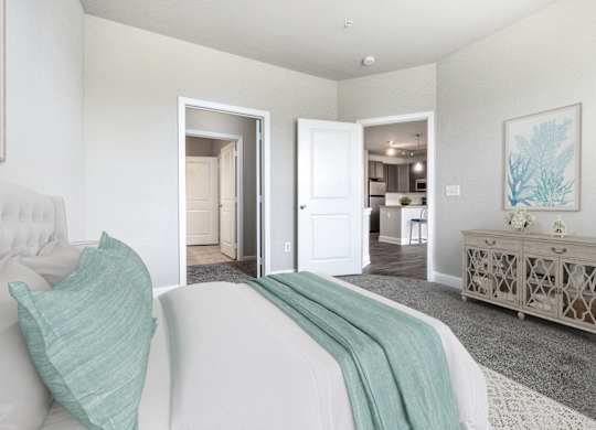 A bedroom with a white bed and a grey cabinet.