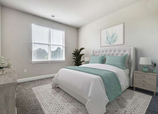 A bedroom with a large bed and a potted plant.