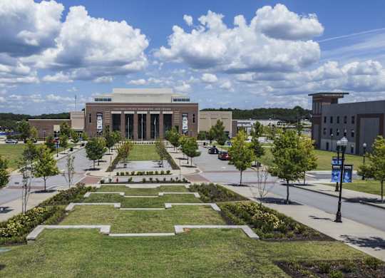 A large building with a long walkway in front of it.