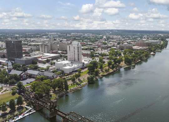 A river flows through a city with a bridge crossing it.