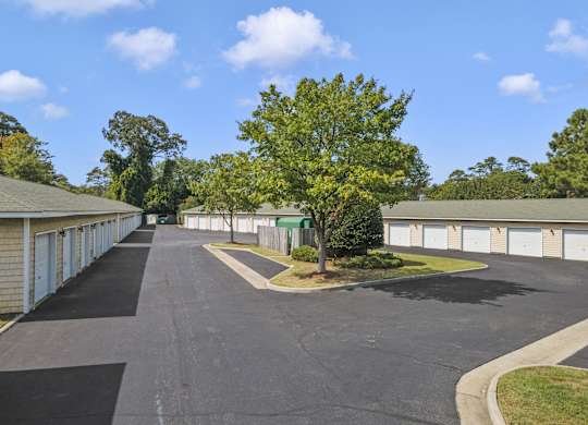 a parking lot with garages on both sides of a street
