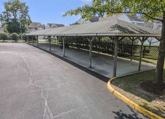 a park with a gazebo on the side of a street
