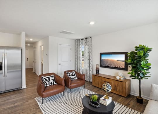 a living room with two chairs and a tv at Summit Place Apartments, Oak Ridge