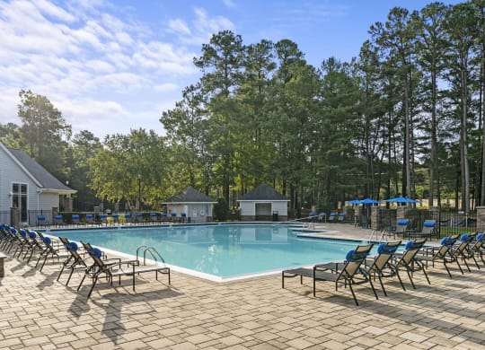 our resort style swimming pool is surrounded by lounge chairs at Trails at Short Pump Apartments, Richmond, Virginia