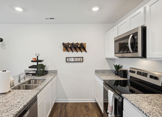 a kitchen with granite counter tops and stainless steel appliances at Summit Place Apartments, Oak Ridge, TN