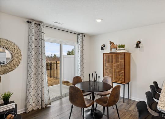 our apartments offer a dining room with a table and chairs and a balcony at Summit Place Apartments, Oak Ridge, Tennessee
