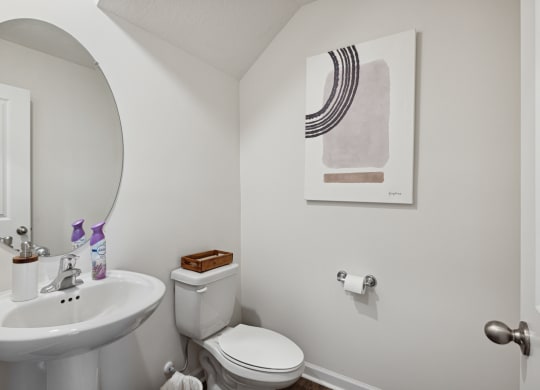 a small bathroom with a sink toilet and a mirror at Summit Place Apartments, Tennessee
