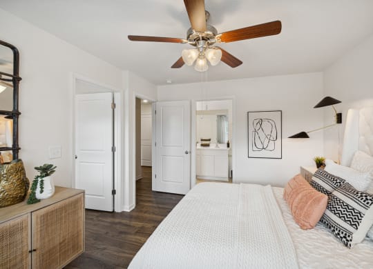 a bedroom with a large bed and a ceiling fan at Summit Place Apartments, Oak Ridge, TN