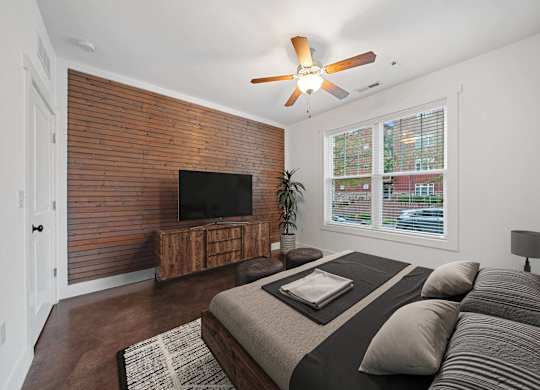 A bedroom with a bed, a tv, and a ceiling fan at Skyloft in Asheville, North Carolina 28803
