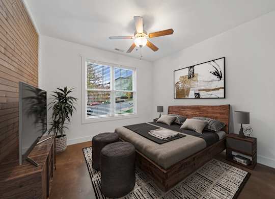 A bedroom with a bed, a ceiling fan, and a window with blinds at Skyloft in North Carolina 28803
