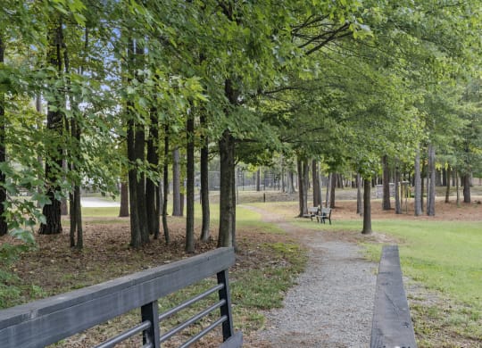 a path through a park with trees and a fence at Trails at Short Pump Apartments, Virginia, 23233
