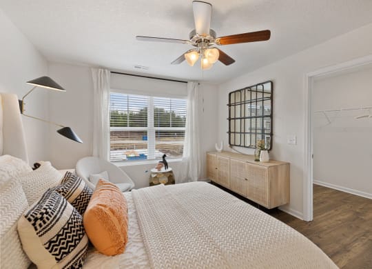 a bedroom with a large bed and a ceiling fan at Summit Place Apartments, Tennessee