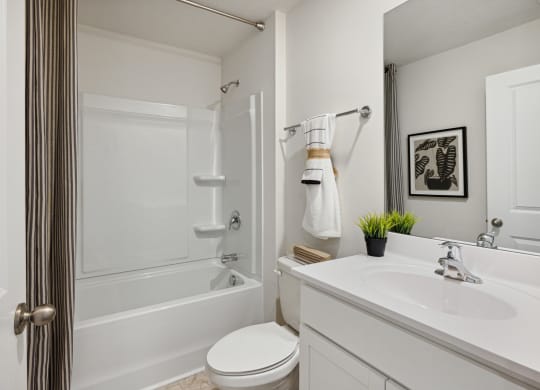 a bathroom with a shower and a sink and a toilet at Summit Place Apartments, Oak Ridge, TN