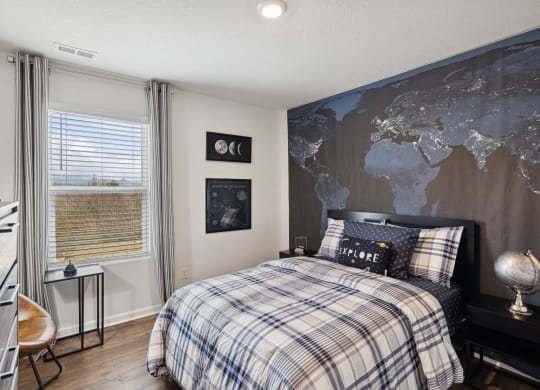 a bedroom with a bed and a map on the wall at Summit Place Apartments, Oak Ridge, TN, 37830