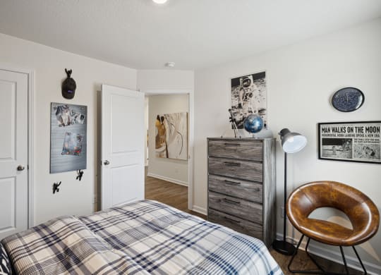 a bedroom with a bed and a dresser at Summit Place Apartments, Oak Ridge