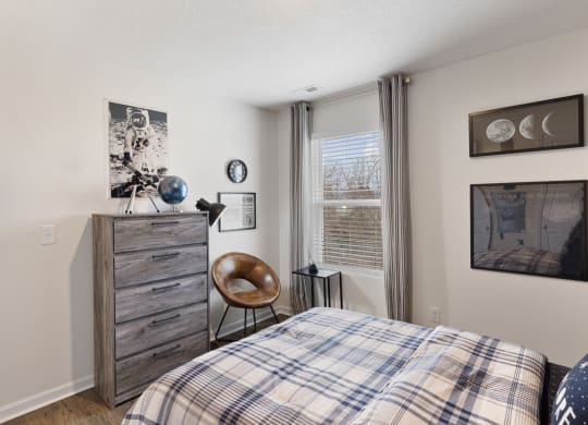 a bedroom with a bed and a dresser and a window at Summit Place Apartments, Tennessee