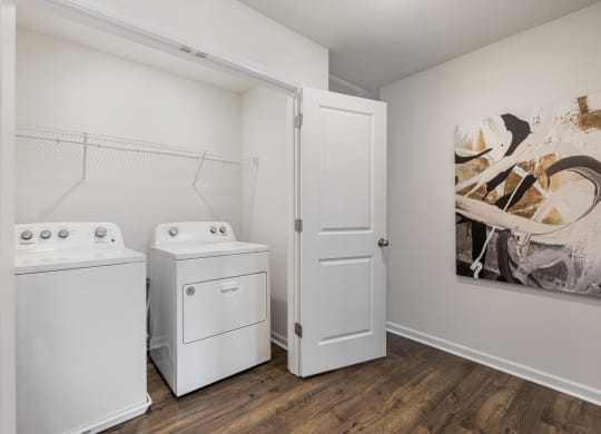 a white washer and dryer in a laundry room with a door at Summit Place Apartments,Tennessee
