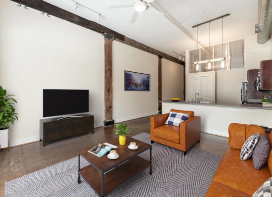 a living room with a couch and a coffee table at Mayton Transfer Lofts in Petersburg, 23803