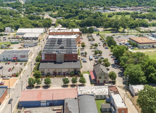 an aerial view of the parking lot and rooftops of buildings in a city at Mayton Transfer Lofts in Petersburg, 23803