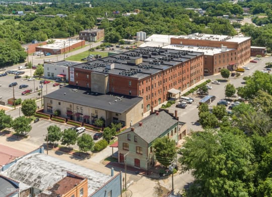 an aerial view of a city with buildings and trees at Mayton Transfer Lofts in Petersburg, VA 