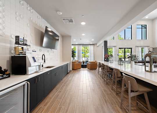 A modern kitchen with wooden floors and a long counter.