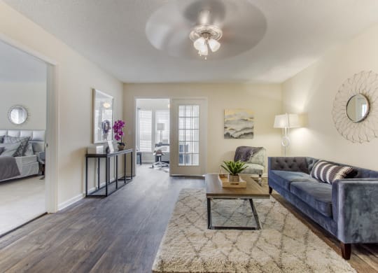 a living room with a couch and a coffee table at Abbington Place Apartments, Greensboro , NC