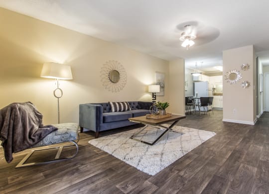 a living room with a couch and a table at Abbington Place Apartments, North Carolina, 27407