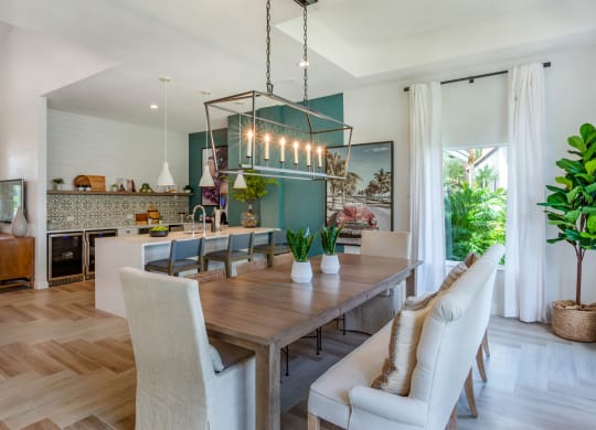 a dining room and kitchen with a wooden table and chairs at The Villas at Ibis Landing, Florida
