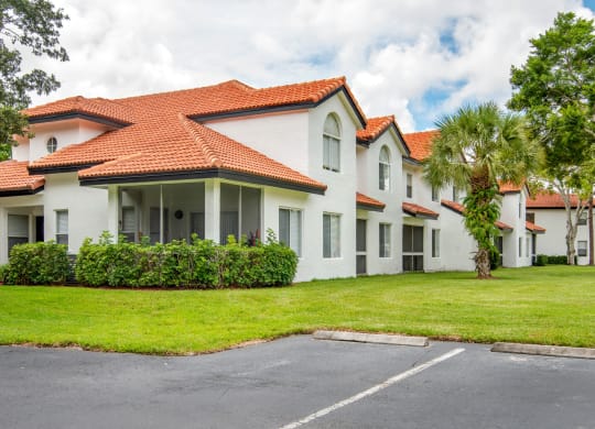a white house with a yard and a palm tree at The Villas at Ibis Landing, Parkland, 33067