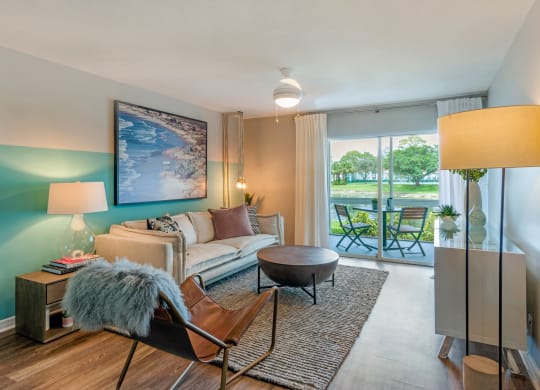 a living room with a couch and a table and a window at The Villas at Ibis Landing, Florida