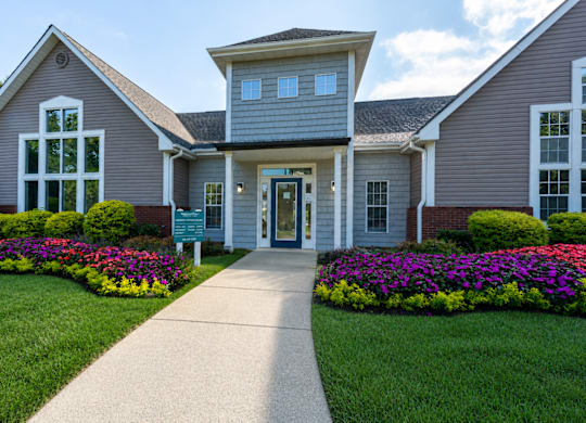 A house with a grey roof and a green lawn in front.