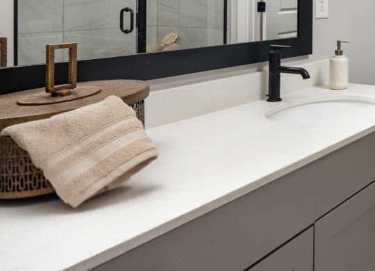 a modern and funky half bathroom reveal with black and white tile in a modern laundry space at The Flats at Southlawn Apartments, Lawrenceville Georgia