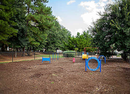 A playground with a blue swing set and a yellow slide.